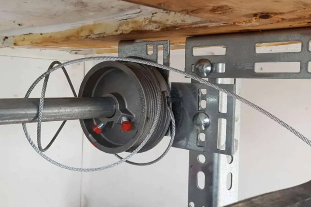 Garage door spring and cable replacement service image featuring a technician working on high-tension torsion springs and steel cables. This service ensures proper door balance, smooth lifting, and safe operation. Professional repair helps prevent accidents, extends the lifespan of your garage door system, and provides dependable performance for residential and commercial properties.